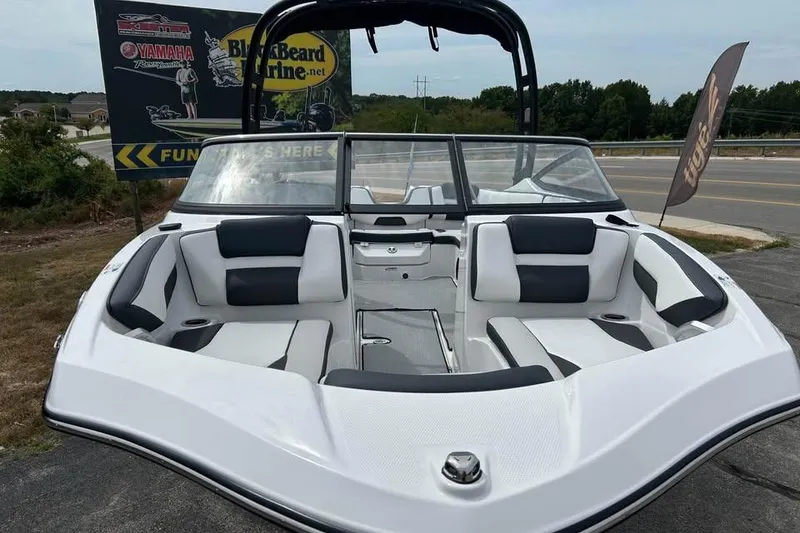 Slide: The Image of 2026 Yamaha Boats AR195 with sleek design and spacious seating, displayed outdoors. - 1