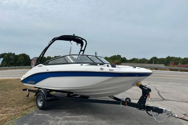 Slide: The Image of 2026 Yamaha Boats AR195 on trailer, parked outdoors near a road. - 3
