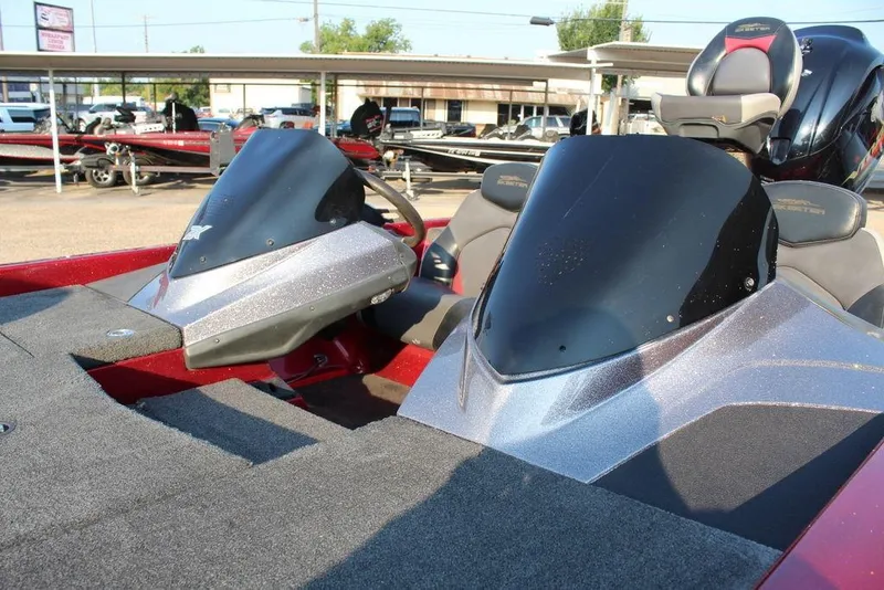 Slide: The Image of 2016 Skeeter ZX250 boat interior with dual consoles and seating, parked outdoors. - 11