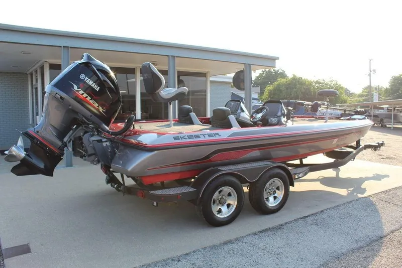 Slide: The Image of 2016 Skeeter ZX250 bass boat with Yamaha engine, parked on a trailer. - 5