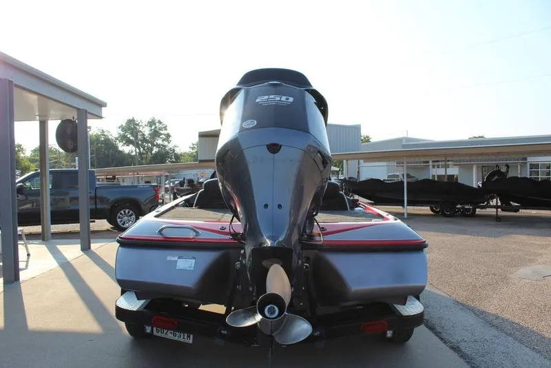Slide: The Image of 2016 Skeeter ZX250 boat with powerful outboard motor, parked outdoors on a sunny day. - 6