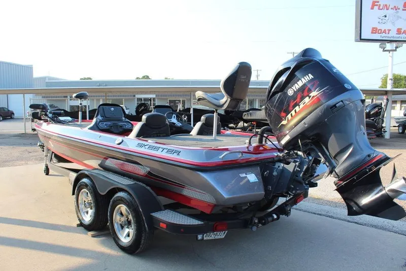 Slide: The Image of 2016 Skeeter ZX250 boat with Yamaha engine on trailer, parked outdoors. - 8