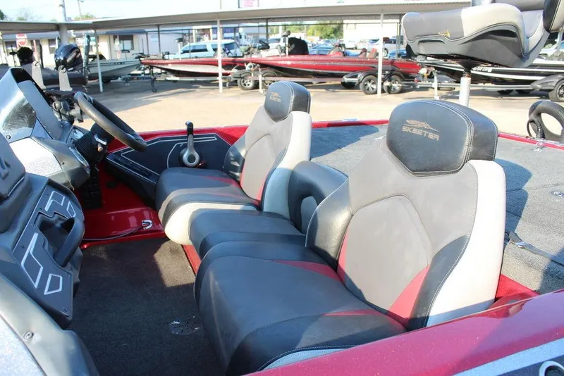 Slide: The Image of 2016 Skeeter ZX250 boat interior with steering wheel and seating. - 9