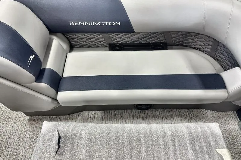 Slide: The Image of 2026 Bennington 22 SSRSE pontoon boat in a warehouse setting. - 10