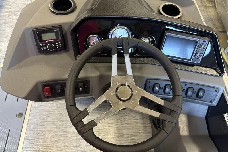 Slide: The Image of 2026 Bennington 22 SSRSE boat dashboard with steering wheel and control panel. - 22