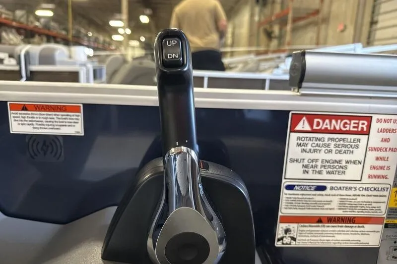 Slide: The Image of Throttle control lever on a 2026 Bennington 22 SSRSE boat with safety warnings. - 23