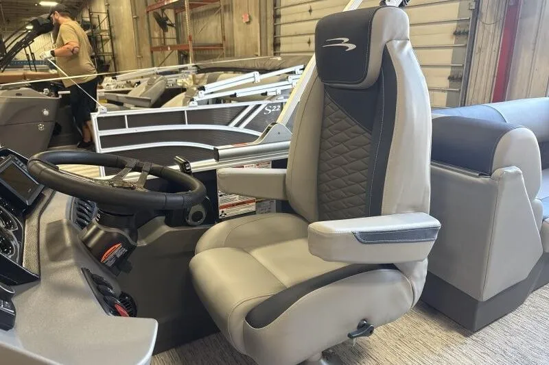 Slide: The Image of 2026 Bennington 22 SSRSE boat interior with luxury captain's chair and steering wheel. - 24