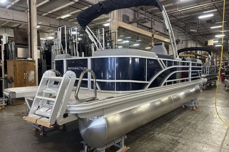 Slide: The Image of 2026 Bennington 22 SSRSE pontoon boat in a warehouse setting. - 6