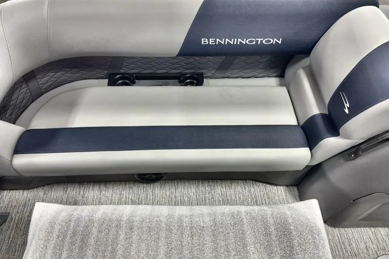 Slide: The Image of 2026 Bennington 22 SSRSE pontoon boat in a warehouse setting. - 7