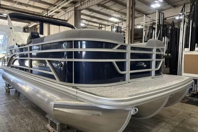 Slide: The Image of 2026 Bennington 22 SSRSE pontoon boat in a warehouse setting. - 9