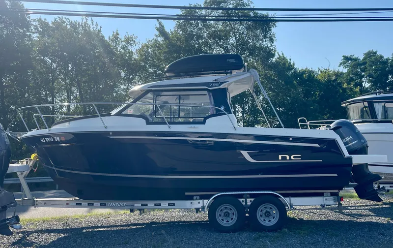 The Image of 2022 Jeanneau NC Weekender 795 Series 2 boat on trailer, side view. - 0