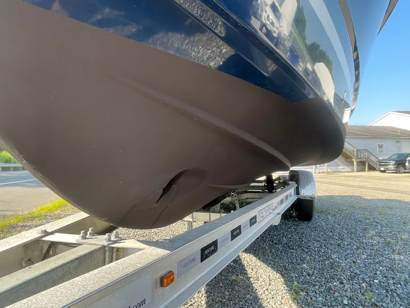 Slide: The Image of 2022 Jeanneau NC Weekender 795 Series 2 on trailer, showing hull and trailer details. - 13