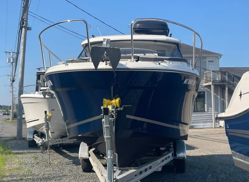 Slide: The Image of 2022 Jeanneau NC Weekender 795 Series 2 boat on trailer, parked outdoors. - 2