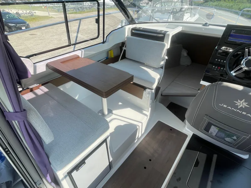 Slide: The Image of Interior of 2022 Jeanneau NC Weekender 795 Series 2, featuring seating and helm area. - 20