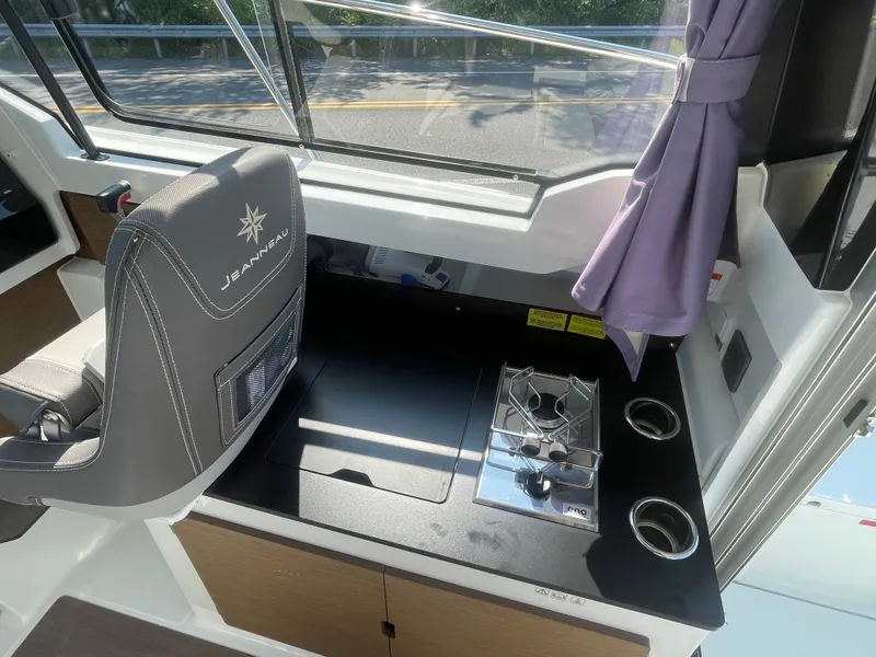 Slide: The Image of Interior of 2022 Jeanneau NC Weekender 795 Series 2 with stove and seating. - 24