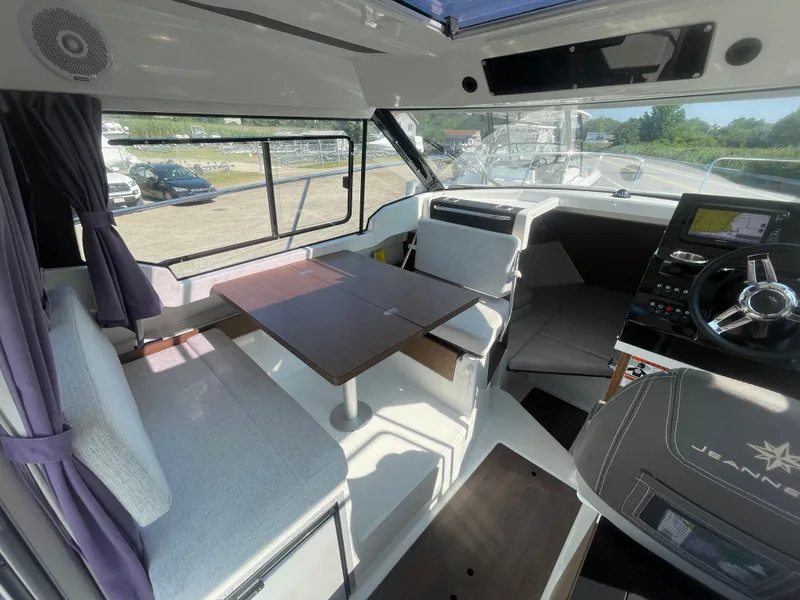 Slide: The Image of Interior of 2022 Jeanneau NC Weekender 795 Series 2 boat, featuring seating and helm. - 27