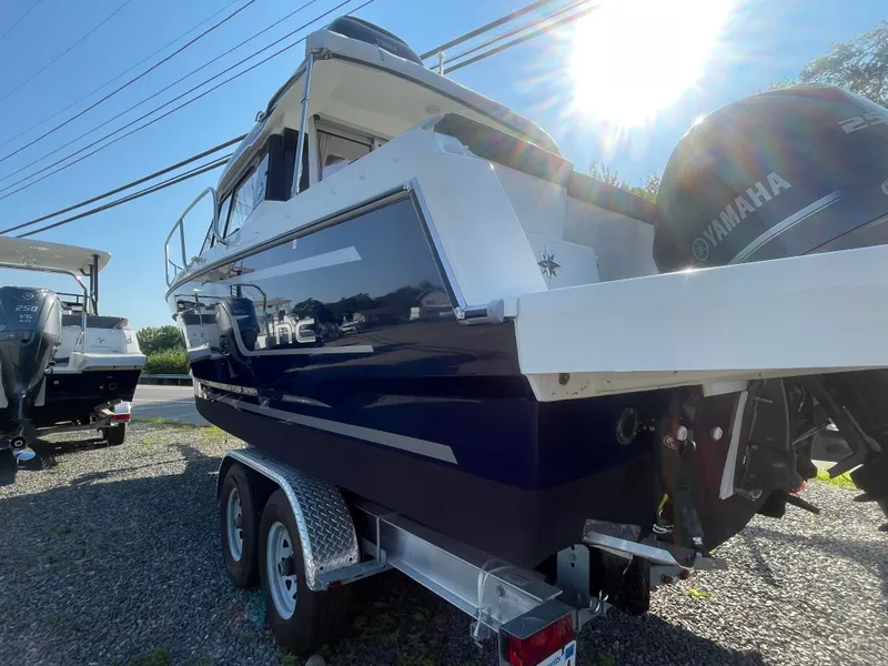 Slide: The Image of 2022 Jeanneau NC Weekender 795 Series 2 boat with Yamaha engine, parked on a trailer. - 3