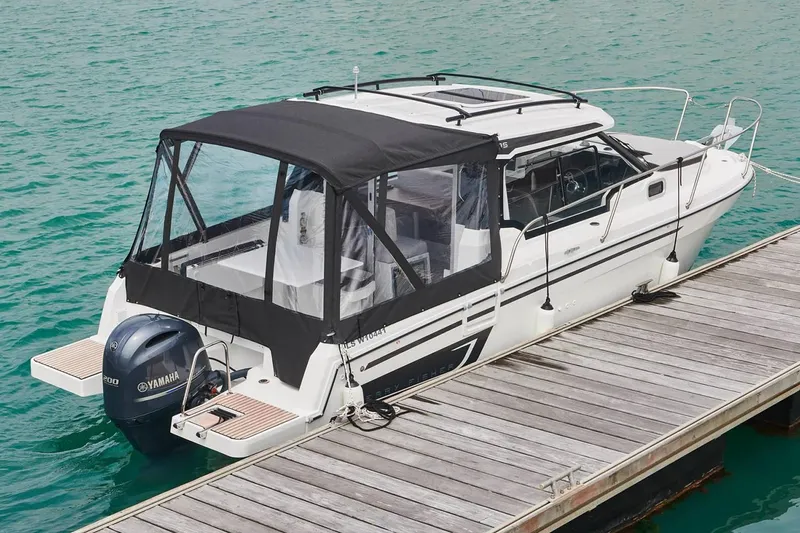 Slide: The Image of Manufacturer Provided Image: 2022 Jeanneau NC Weekender 795 Series 2 docked, rear view with Yamaha outboard motor. - 32