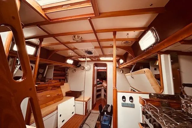 Slide: The Image of Interior of 1993 Brooklin Boat Yard Marshall 48, featuring wooden finishes and nautical design. - 17