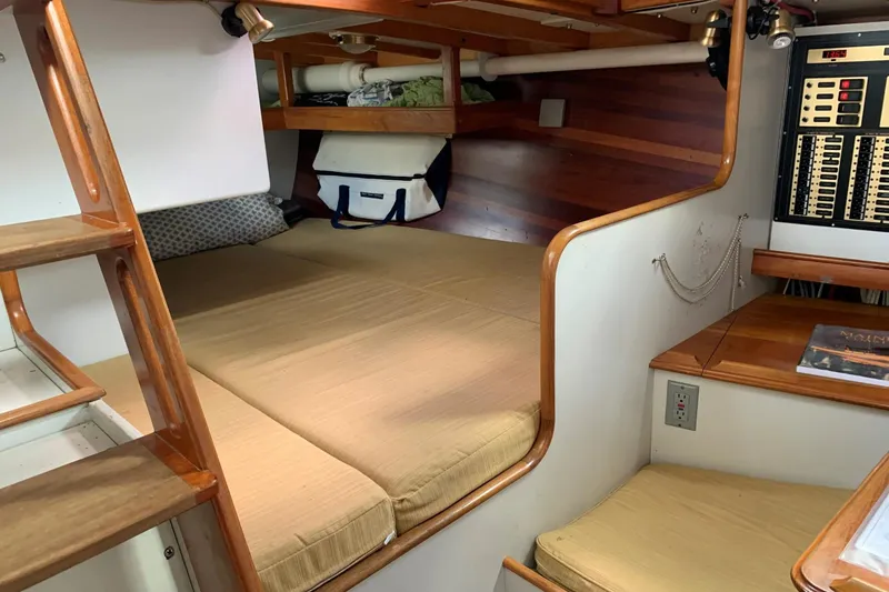 Slide: The Image of Interior of 1993 Brooklin Boat Yard Marshall 48, featuring cozy sleeping area and control panel. - 18
