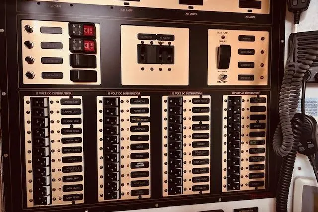 Slide: The Image of Control panel of a 1993 Brooklin Boat Yard Marshall 48, featuring switches and meters. - 23