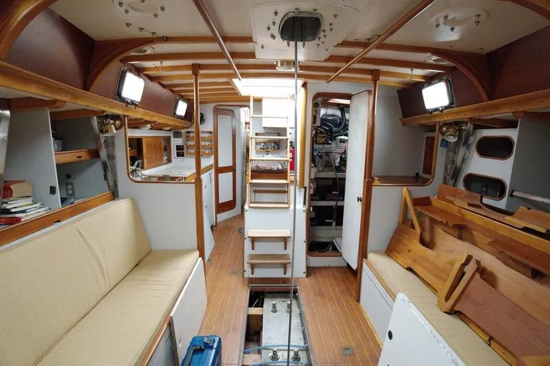 Slide: The Image of Interior of 1993 Brooklin Boat Yard Marshall 48, featuring wooden finishes and seating. - 26