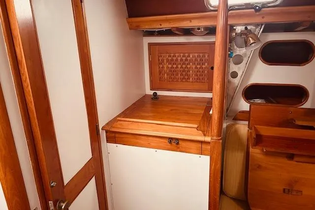 Slide: The Image of Interior of 1993 Brooklin Boat Yard Marshall 48 with wooden cabinetry and nautical design. - 32