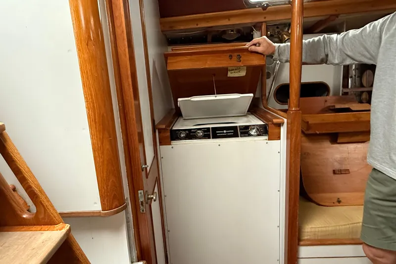 Slide: The Image of Interior of 1993 Brooklin Boat Yard Marshall 48, featuring a compact kitchen area. - 33