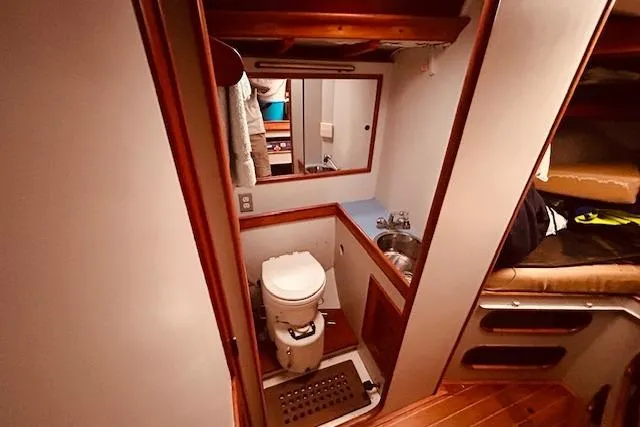 Slide: The Image of Interior of 1993 Brooklin Boat Yard Marshall 48, featuring compact bathroom with sink and toilet. - 36