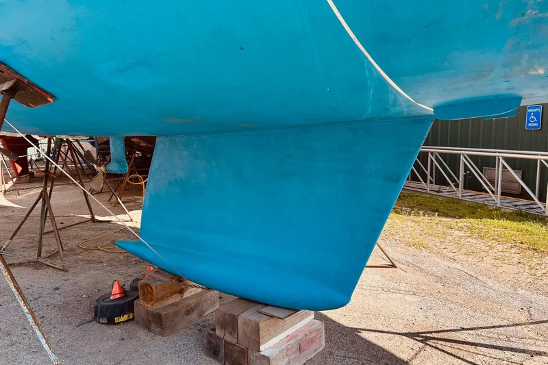 Slide: The Image of Blue hull of 1993 Brooklin Boat Yard Marshall 48 sailboat on dry dock. - 45