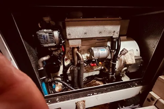 Slide: The Image of Engine compartment of a 1993 Brooklin Boat Yard Marshall 48, showcasing mechanical components. - 54