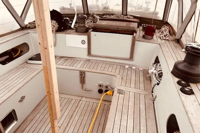 Slide: The Image of 1993 Brooklin Boat Yard Marshall 48 interior with wooden deck and nautical equipment. - 58