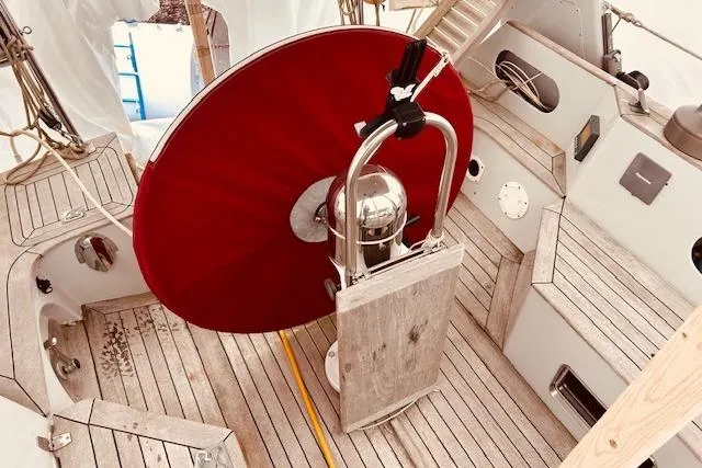 Slide: The Image of Cockpit of 1993 Brooklin Boat Yard Marshall 48 with red wheel and wooden deck. - 62