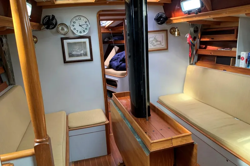 Slide: The Image of Interior of 1993 Brooklin Boat Yard Marshall 48, featuring cozy seating and nautical decor. - 7