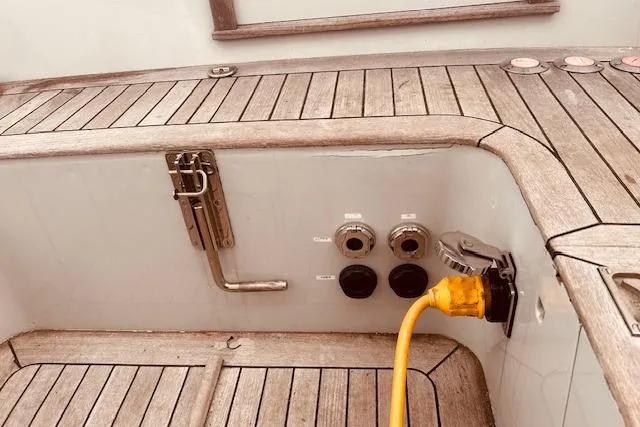 Slide: The Image of Teak deck of 1993 Brooklin Boat Yard Marshall 48 with power connections. - 76