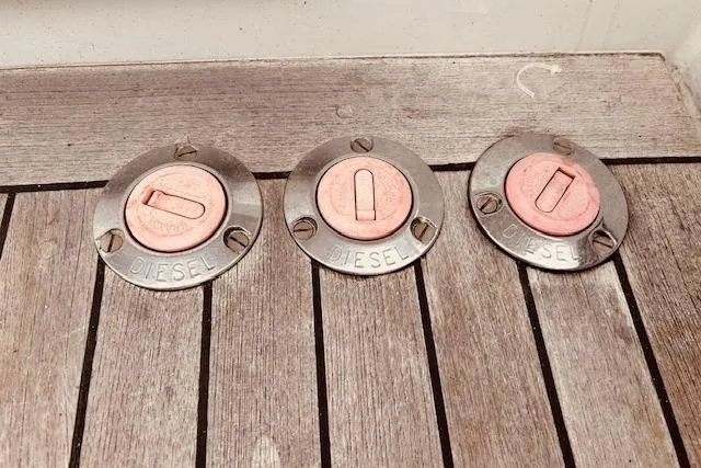 Slide: The Image of Diesel fuel caps on 1993 Brooklin Boat Yard Marshall 48 wooden deck. - 77