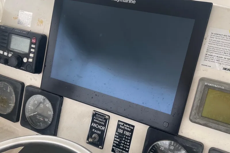 Slide: The Image of Control panel of a 2001 Pursuit 3000 Offshore boat with navigation and communication equipment. - 5