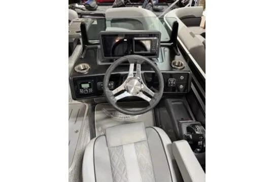 Slide: The Image of 2025 Bennington 22M FASTBACK boat dashboard with steering wheel and modern controls. - 10