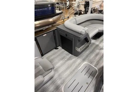 Slide: The Image of 2025 Bennington 22M FASTBACK pontoon boat interior with gray seating and flooring. - 11