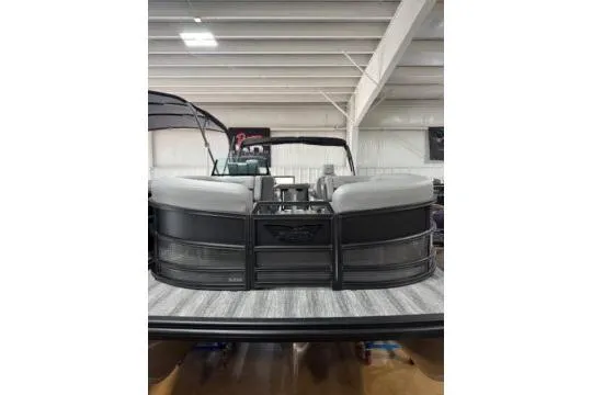 Slide: The Image of 2025 Bennington 22M FASTBACK pontoon boat in showroom, rear view. - 3