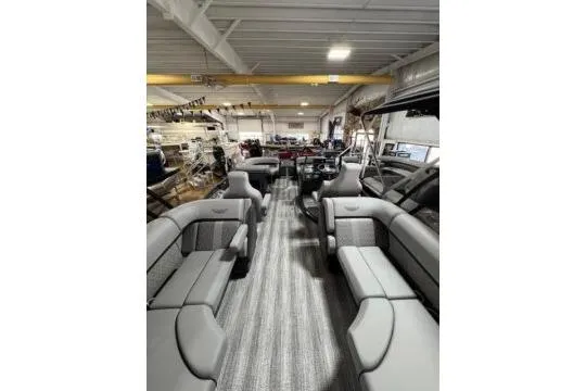 Slide: The Image of 2025 Bennington 22M FASTBACK interior with spacious seating in a showroom. - 8