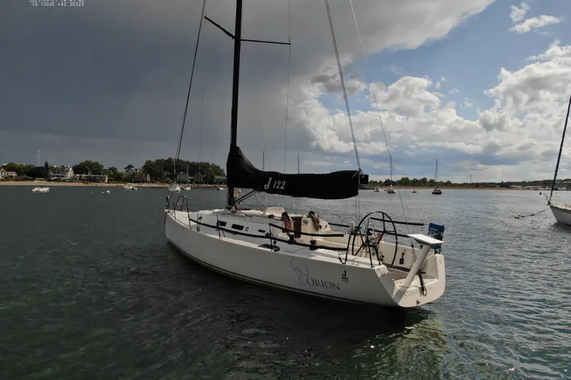 Slide: The Image of Sailboat J/122 from 2013 by J Boats, docked on a calm waterway under cloudy skies. - 11