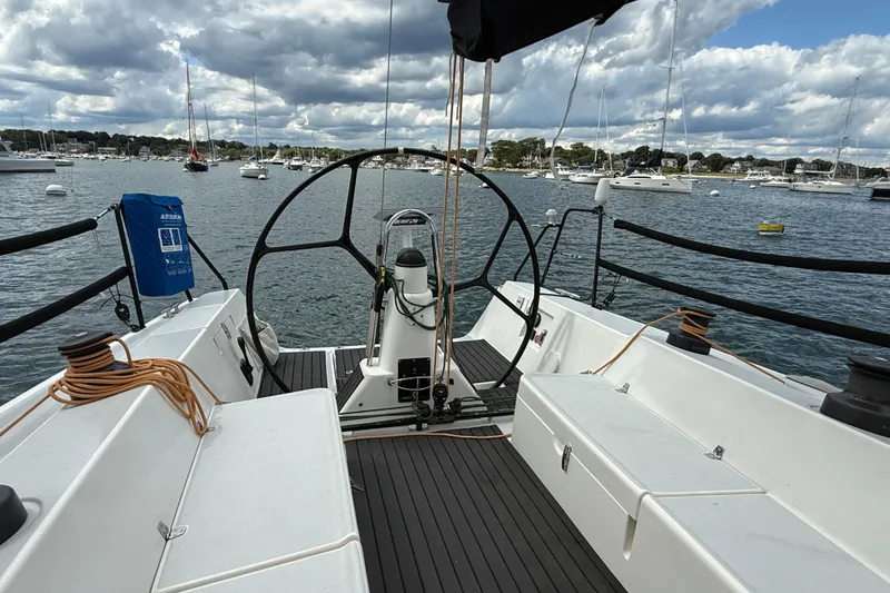 Slide: The Image of 2013 J Boats J/122 sailboat cockpit with scenic harbor view and moored boats. - 14