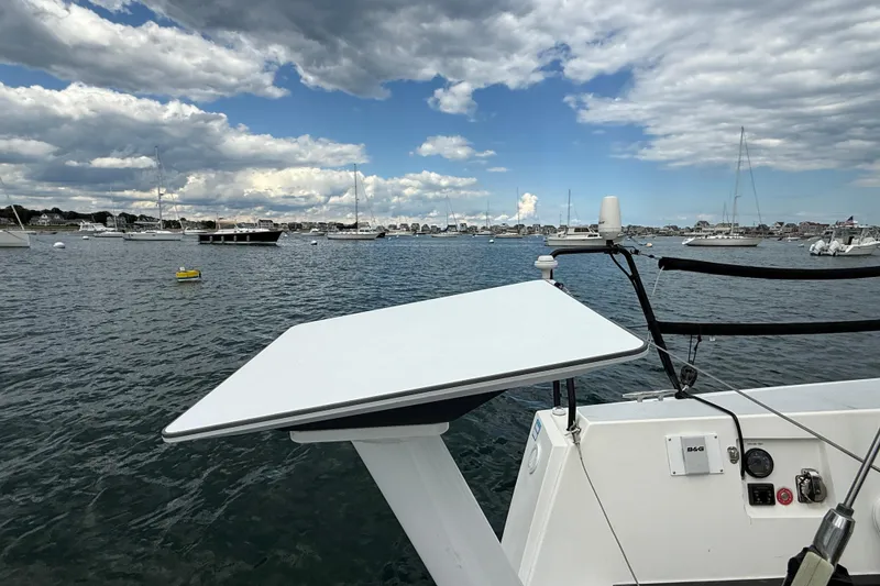 Slide: The Image of Sailboat J/122 (2013) on water, featuring deck equipment and scenic harbor view. - 19
