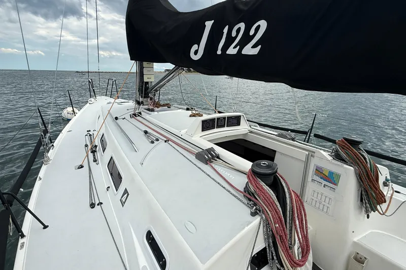 Slide: The Image of 2013 J Boats J/122 sailboat deck with rigging and open cockpit on the water. - 22