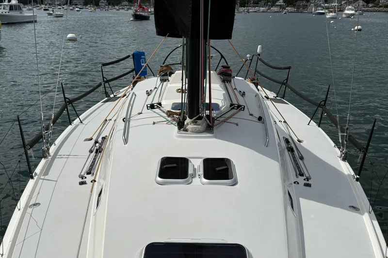 Slide: The Image of 2013 J Boats J/122 sailboat deck view, moored in a marina with surrounding boats. - 27