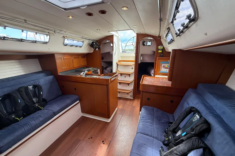 Slide: The Image of Interior of 2013 J Boats J/122 sailboat with wood finish and blue seating. - 35