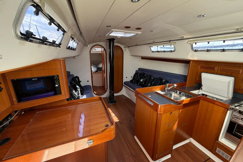 Slide: The Image of Interior of 2013 J Boats J/122 sailboat with wood finish, kitchenette, and seating area. - 44
