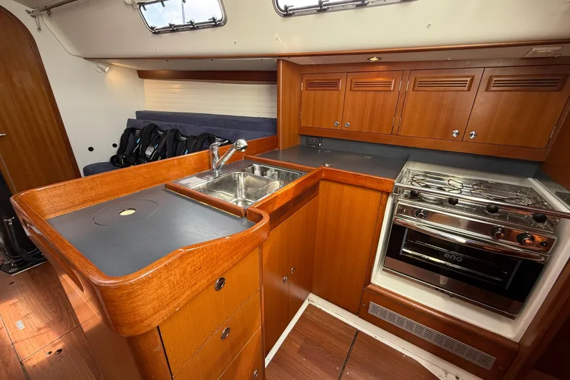 Slide: The Image of Interior of 2013 J Boats J/122 yacht featuring a modern kitchen with wood cabinetry. - 46