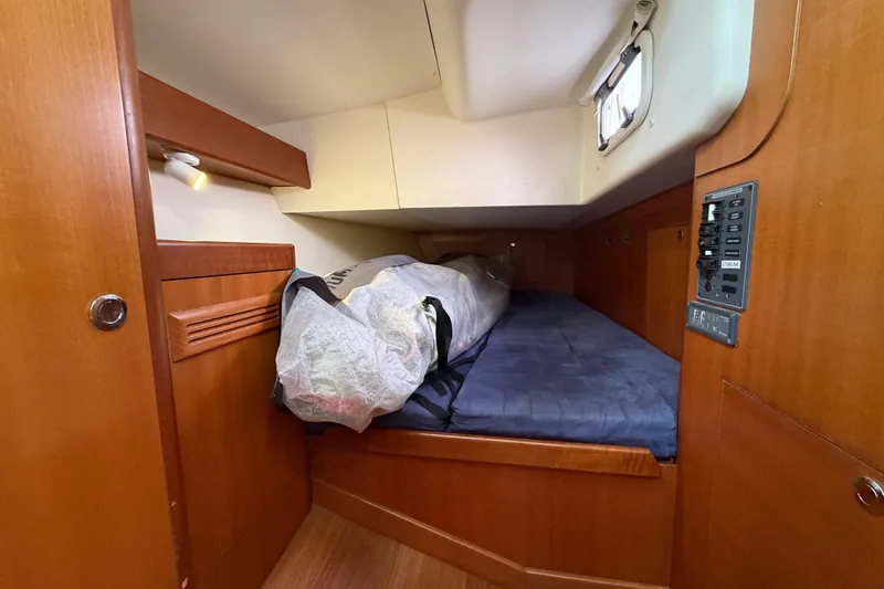 Slide: The Image of 2013 J Boats J/122 cabin interior with wooden finish and cozy sleeping area. - 49